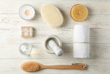 Flat lay with spa accessories on white wooden background. Bodycare